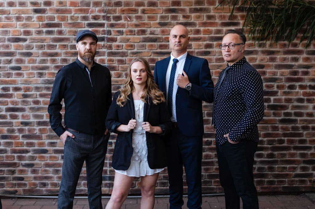 Midnight Fizz — full lineup in front of a brick wall, Bay of Plenty