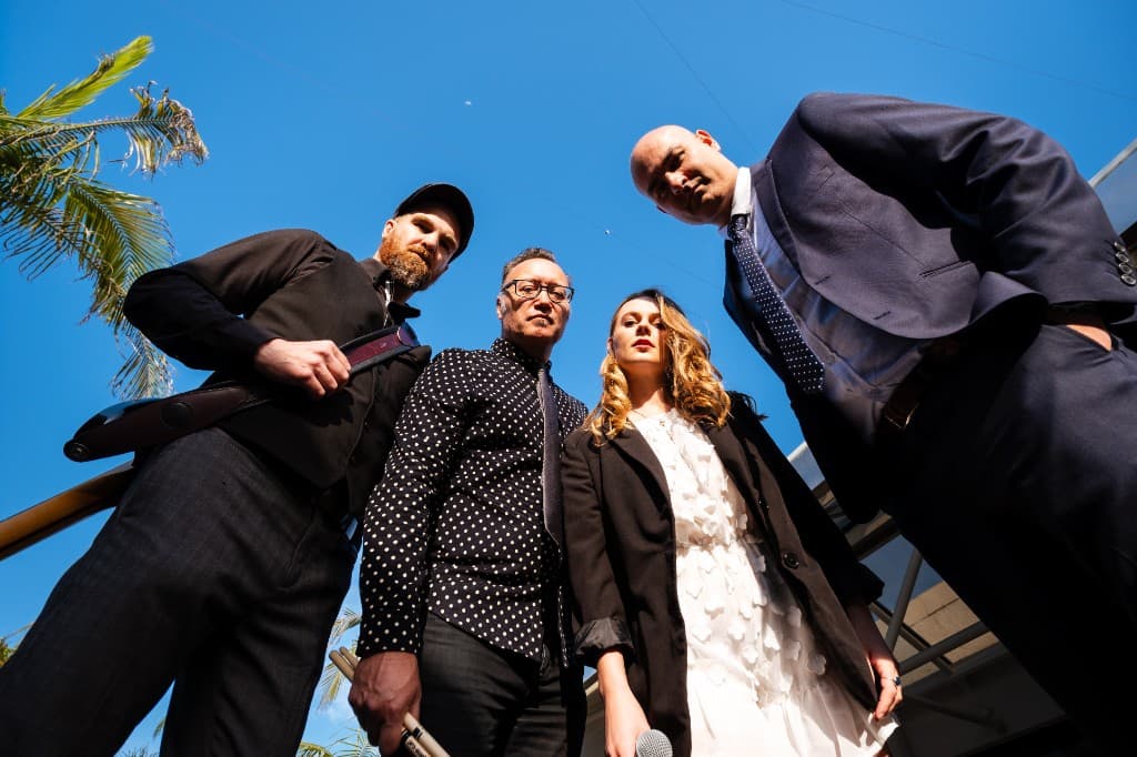 Midnight Fizz — low-angle group shot against blue sky